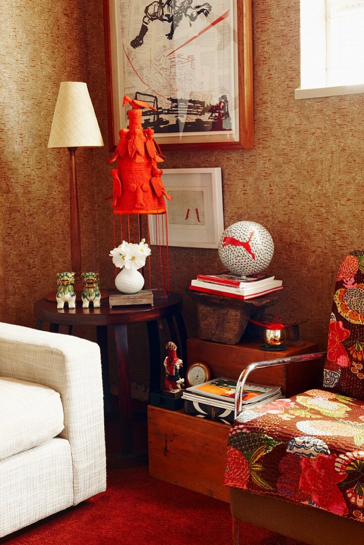 Table lamp on side table flanked by upholstered armchairs in corner of living room