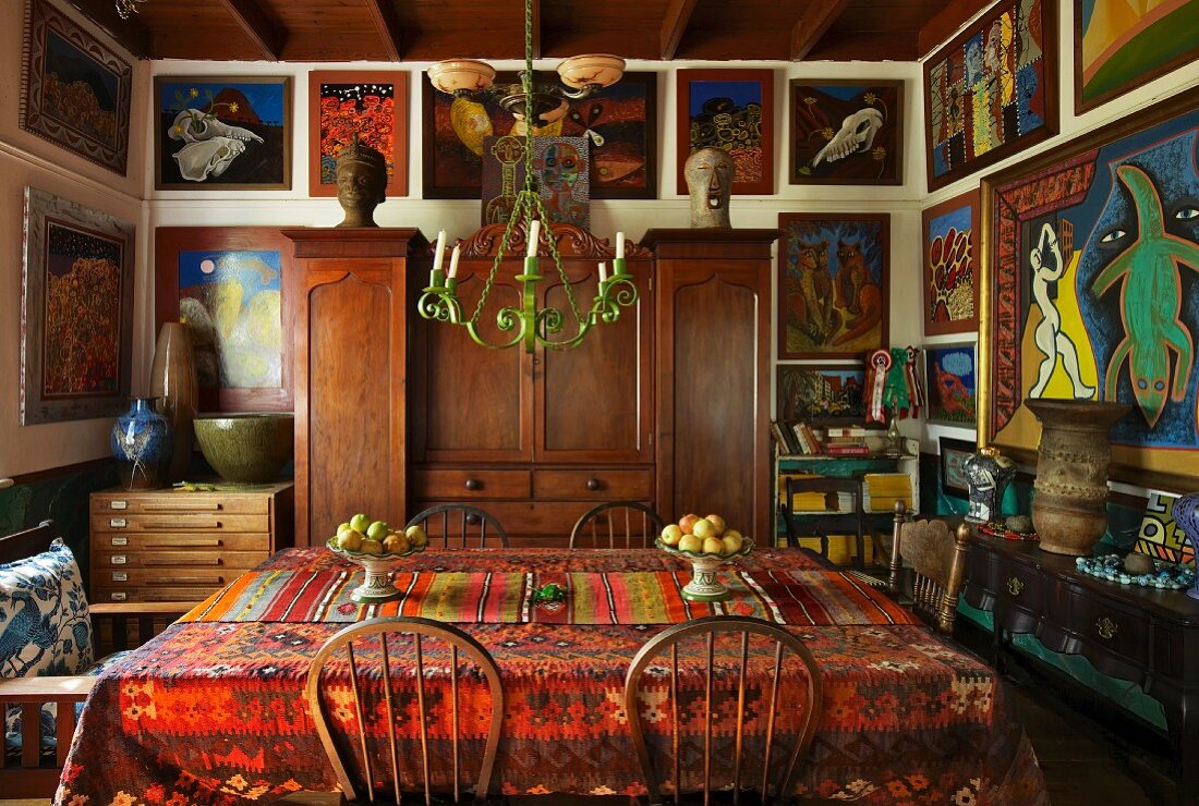Dining room with closely spaced gallery of pictures on walls