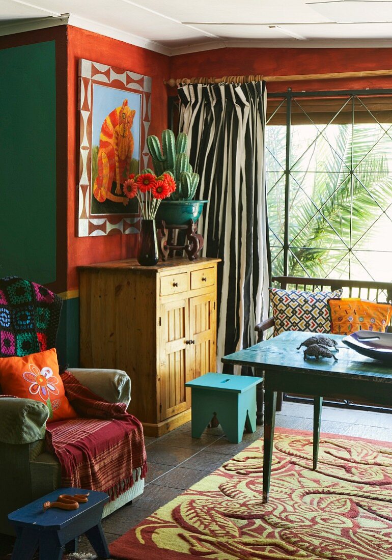 Interior with coloured walls and mixture of textile patterns