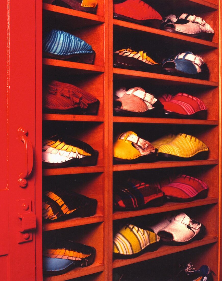 A shoe cupboard made from red-painted wood