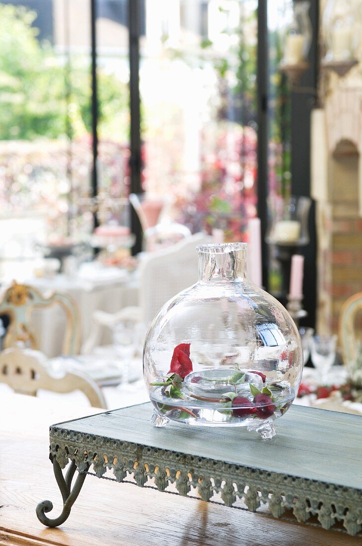 Rosebuds in decorative, hand-blown glass vase