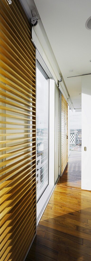 Detail of modern interior with wooden slats in front of window