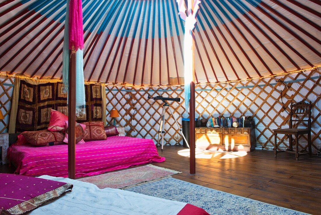 Interior of Mongolian yurt with strong sunlight falling through roof