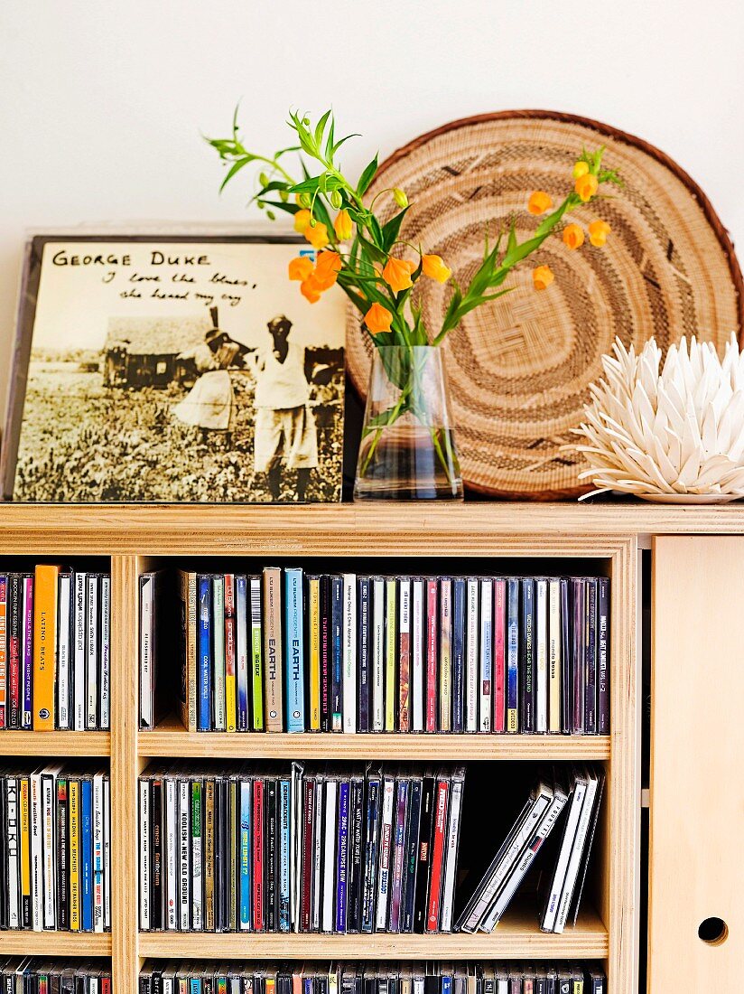 Bouquet on modern cabinet with integrated CD shelves