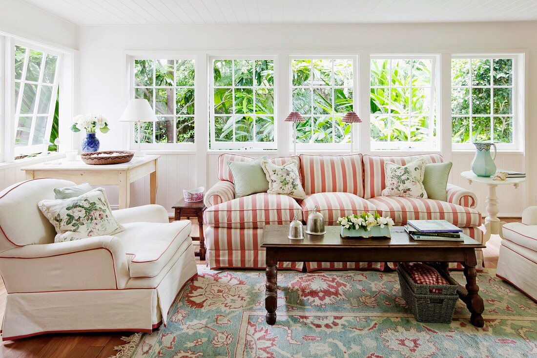 Comfortable living room with luxurious, upholstered seating in romantic, English country-house style