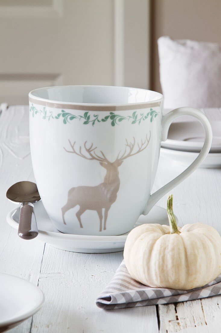 Place setting with ornamental gourd and hunting motif on cup