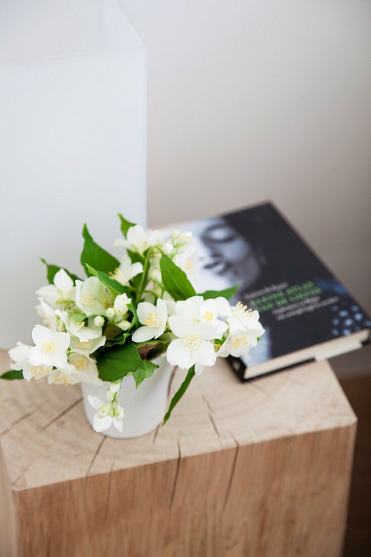 Hellebore and book on wooden block