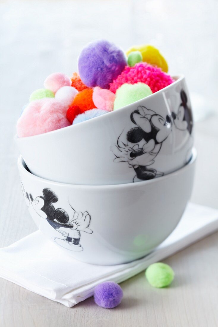 Mickey Mouse bowls filled with colourful pompoms