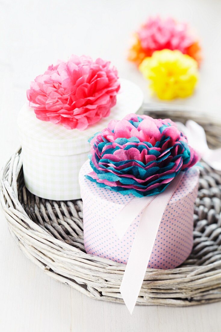 Gift boxes decorated with tissue paper pompoms