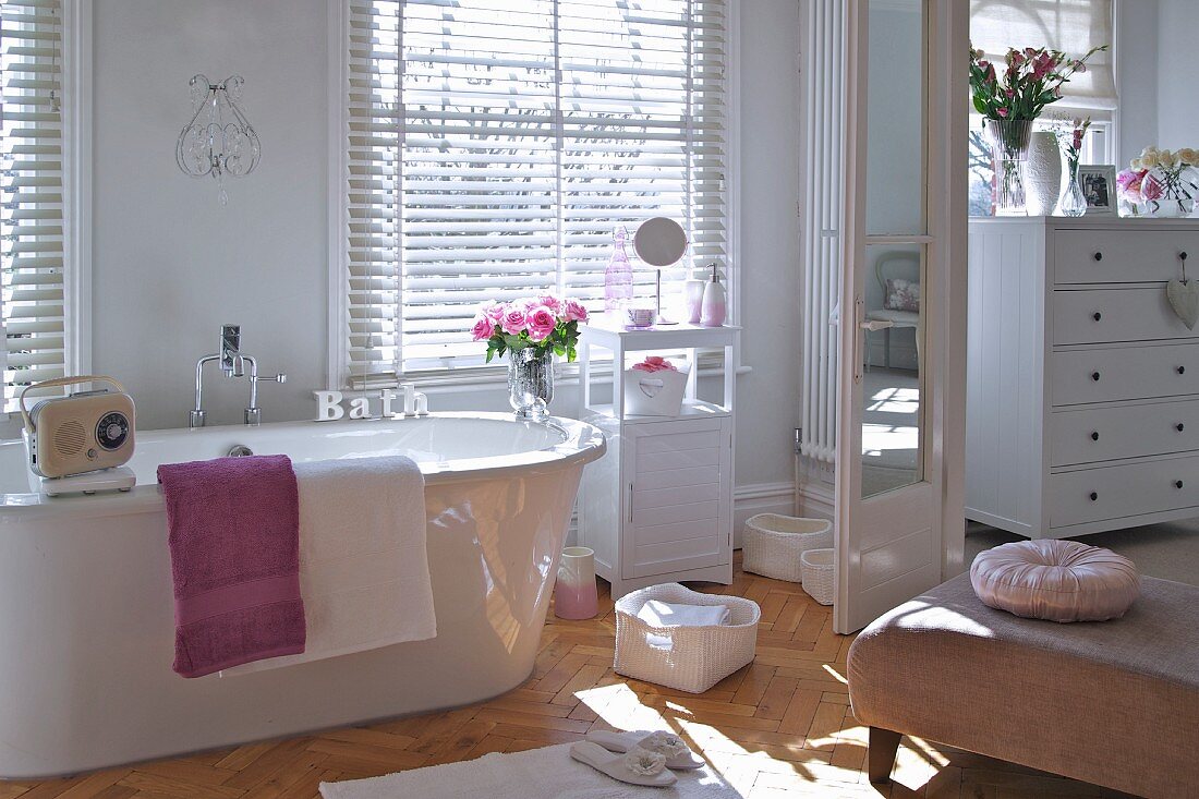 Elegant white bathroom with blinds at windows