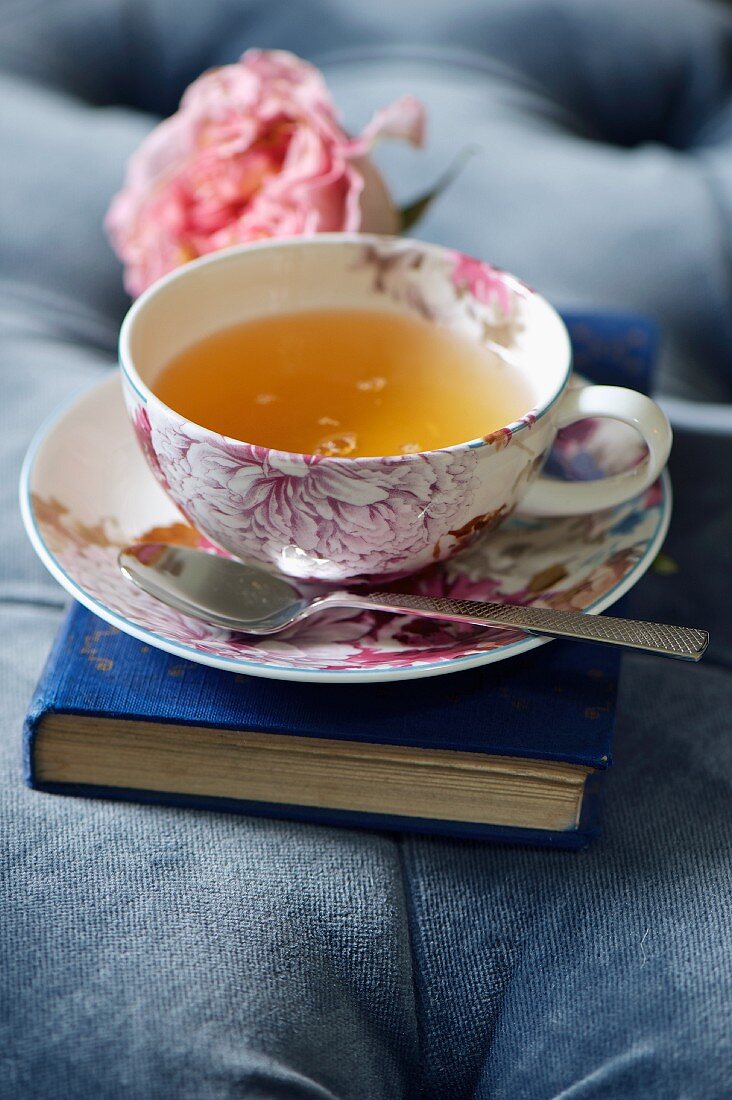Tea, in a teacup with a floral pattern