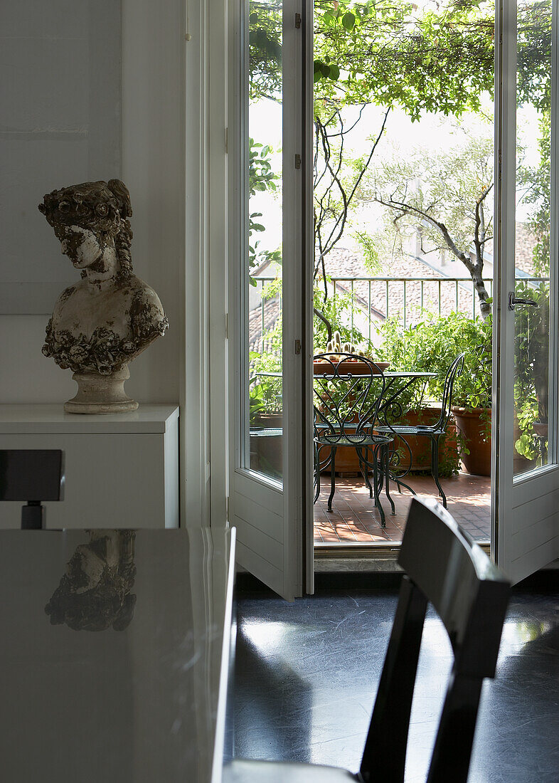 View from dining room to balcony in green surroundings