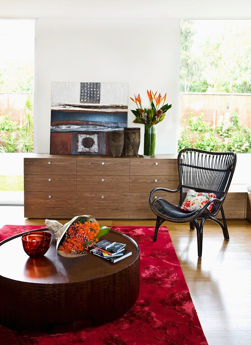 Interior with walnut-veneer chest of drawers & round coffee table