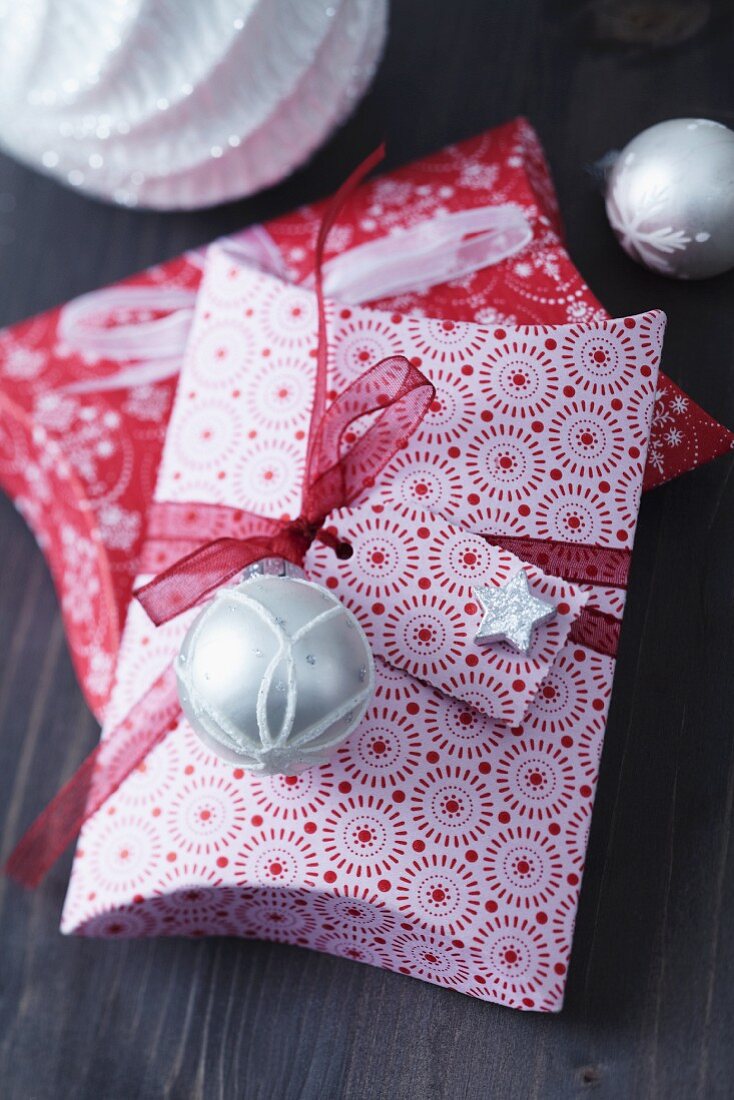 Folded pillow boxes decorated with small Christmas tree baubles
