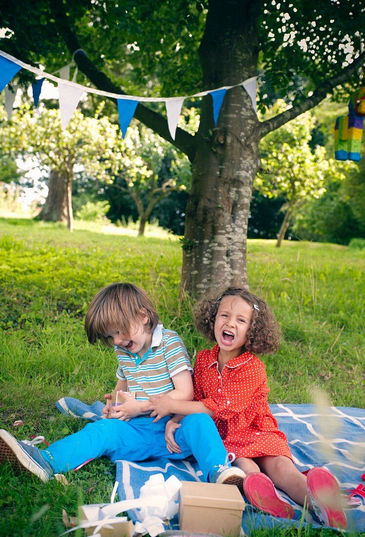 Children at a birthday picnic in garden