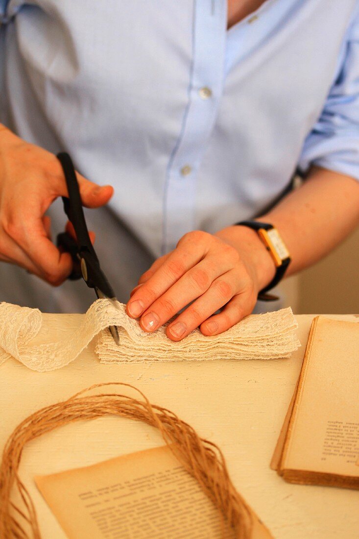 Woman cutting lace ribbon into pieces