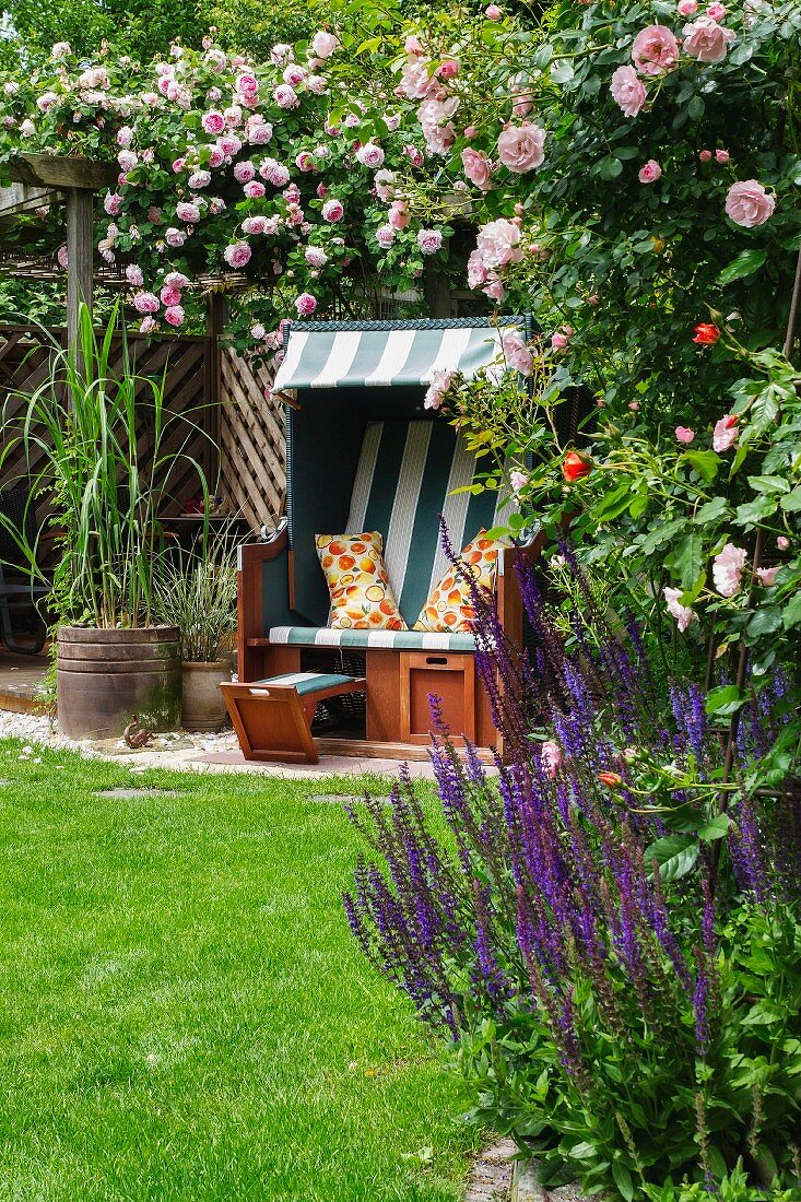 Wicker beach chair in rose garden