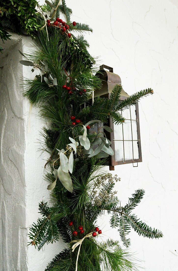 Christmas garland of pine and fir branches on house facade