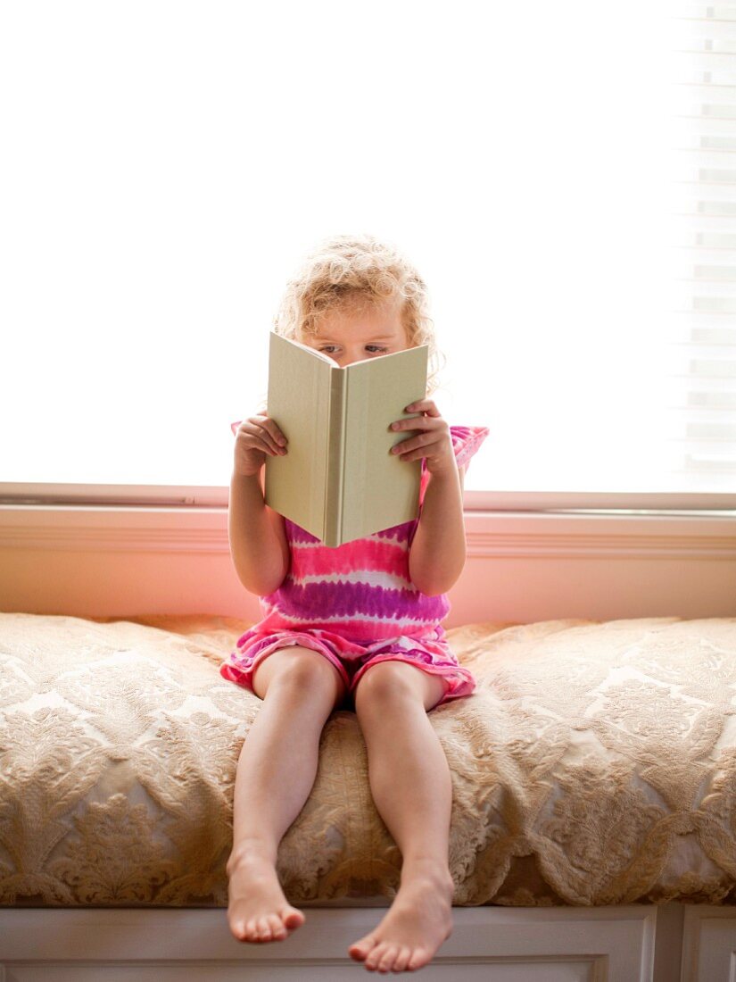 Girl sitting and reading book