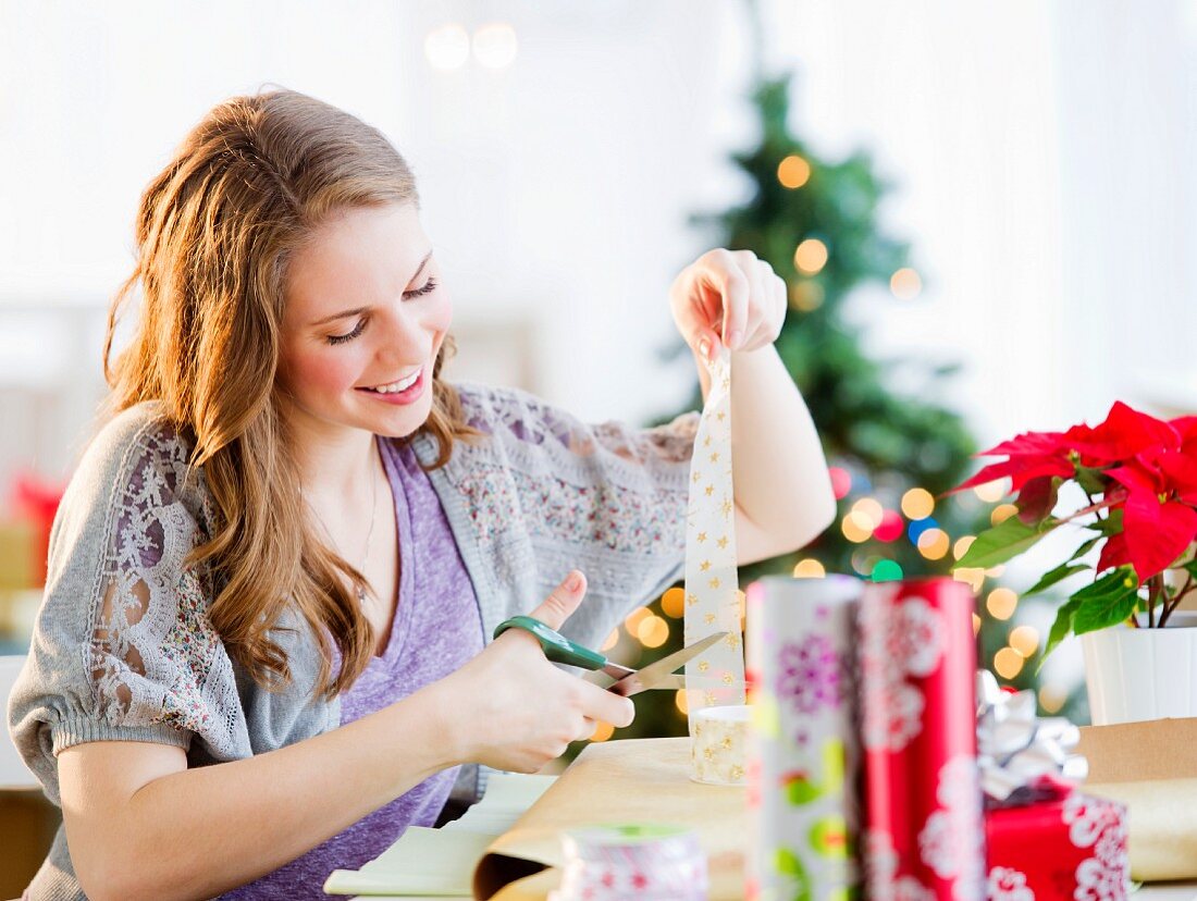 A woman wrapping Christmas gifts