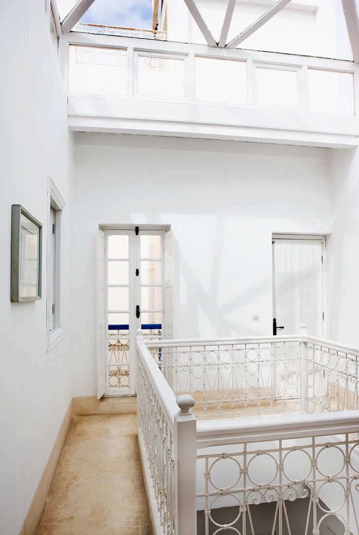 Gallery landing with artistically crafted balustrade lit from above by skylight