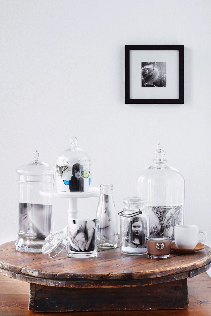 Photos of children in attractive glass jars on rustic wooden table