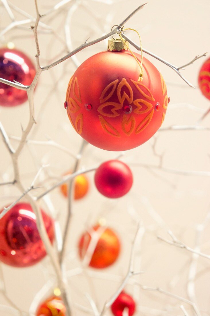 Christmas tree baubles hanging on white twigs