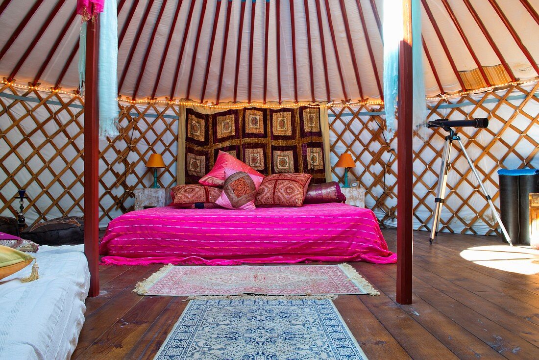 King sized double bed in a luxurious traditional Mongolia yurt or tend, in a holiday resort