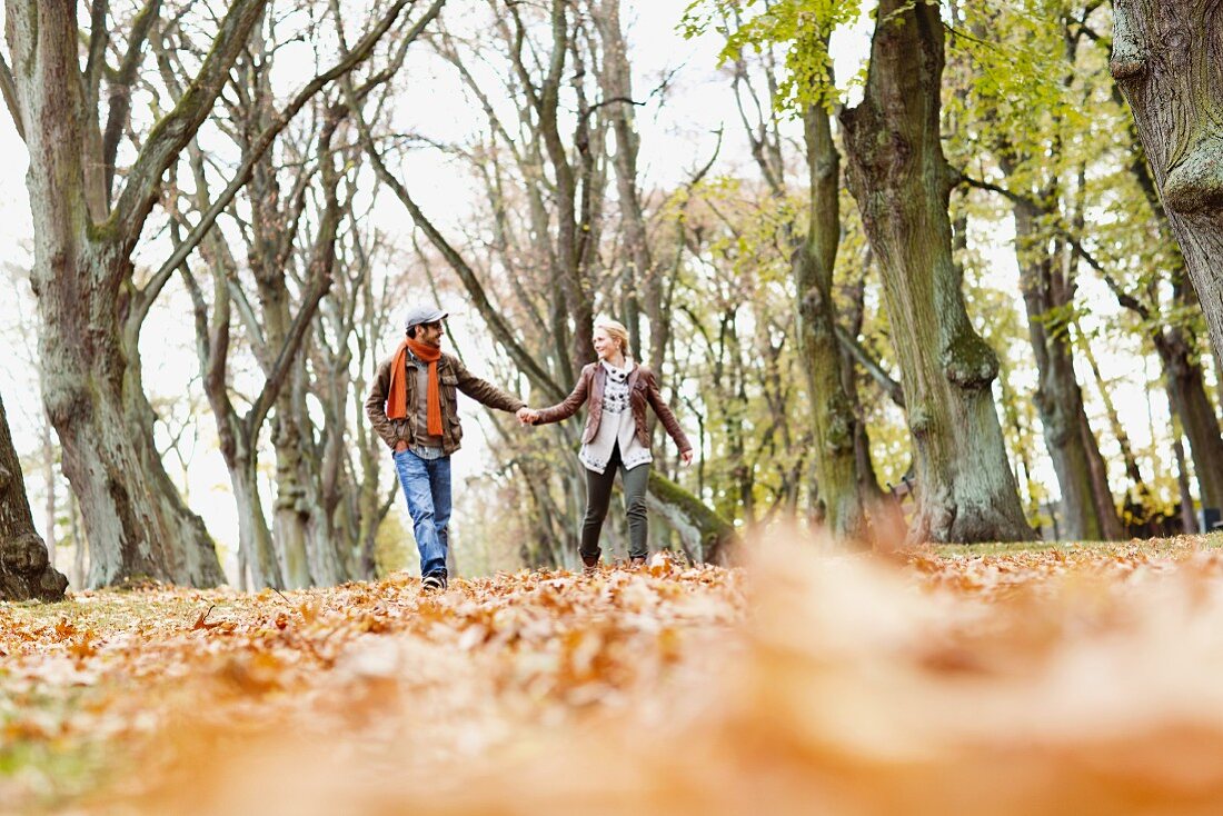 Couple strolling through autumnal woodland