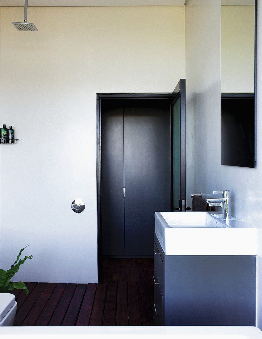 Washstand in purist bathroom with exotic wood board floor