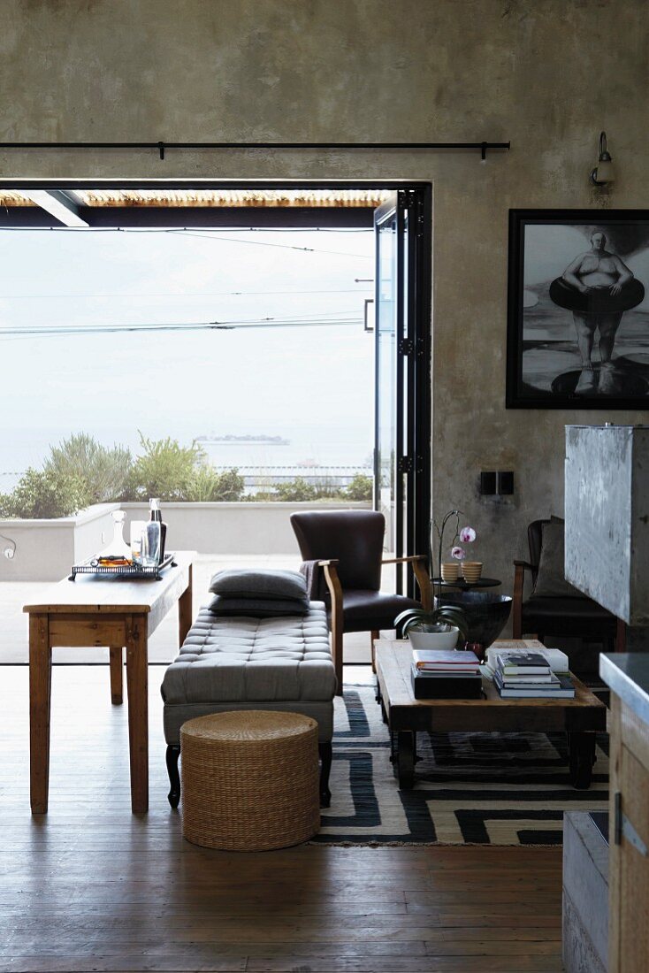 View of terrace and sea from living room with shabby-chic walls
