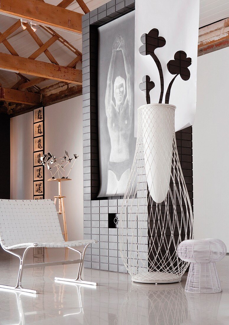 Detail of room with mural, designer chair, floor vase and objet d'art