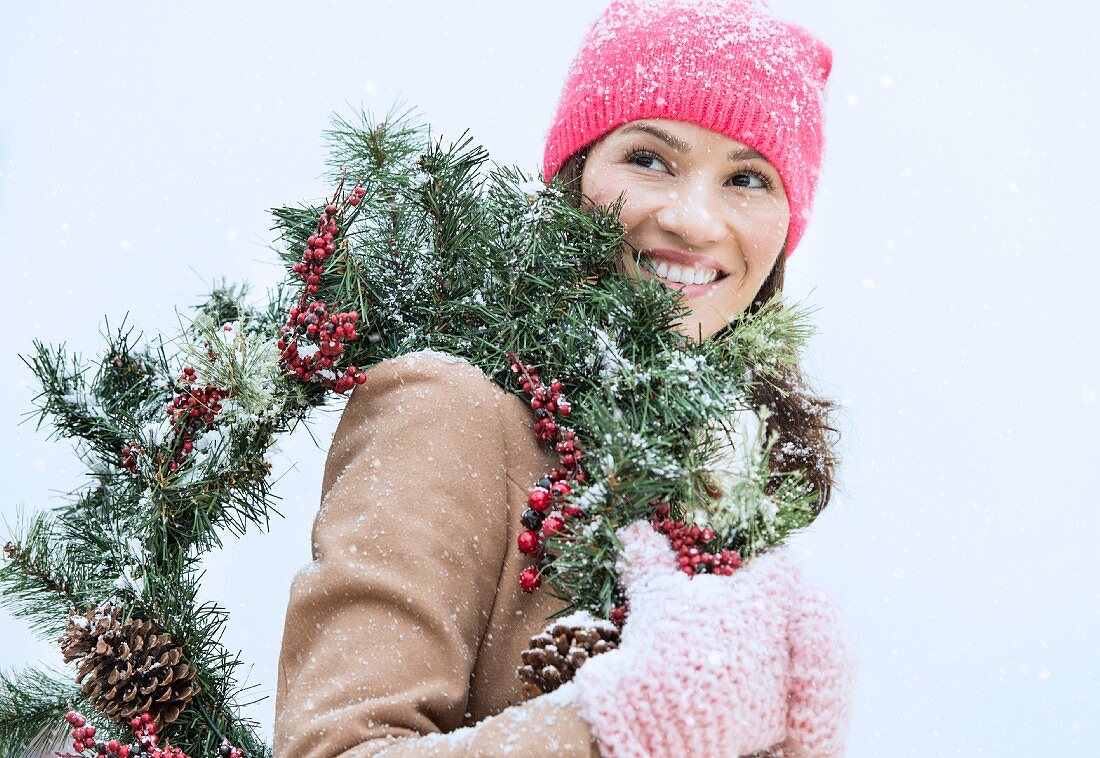 Woman carrying Christmas wreath