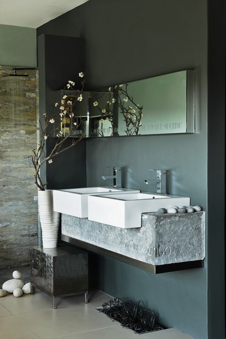 Designer bathroom - washstand with twin basins and stone base in niche painted dark grey
