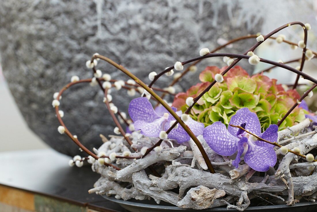 Wreath of willow twigs with catkins, orchids and hydrangea flower