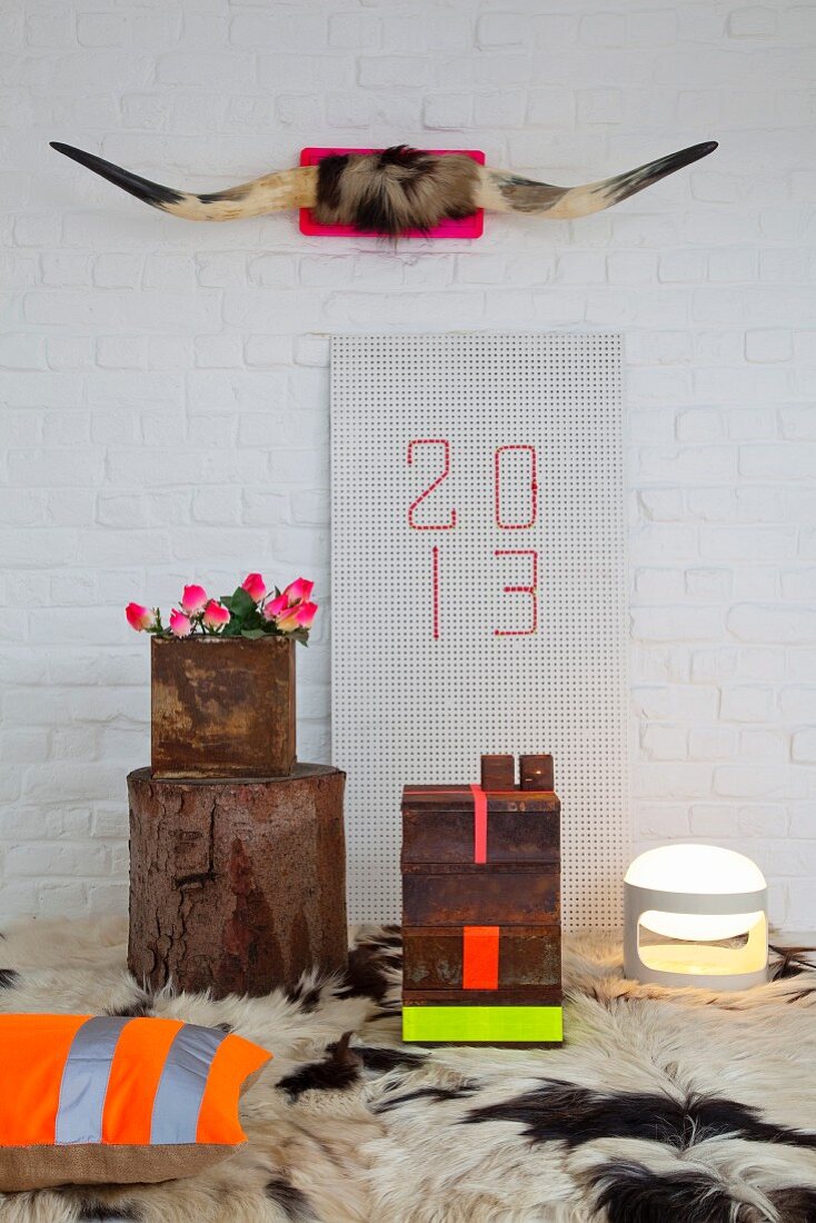 Bull horns on pink panel on wall above New Year 2013 arrangement with neon accents