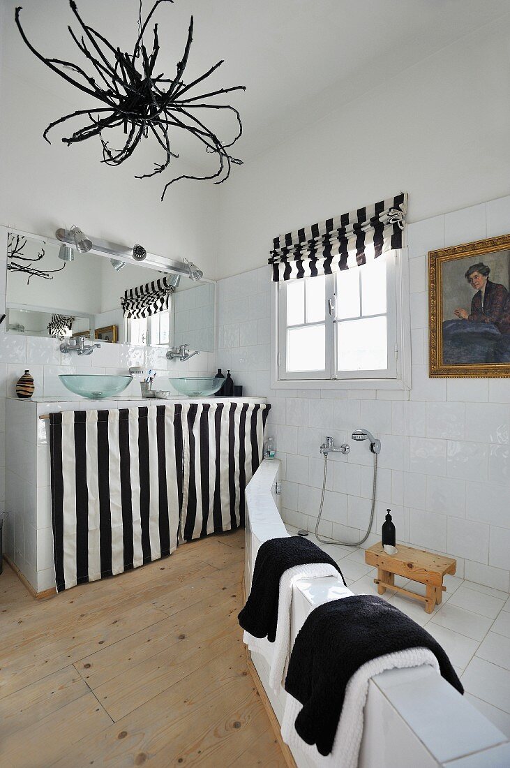 Bathroom with oriental theme: brick shower area and black and white textiles; dried root used for lampshade
