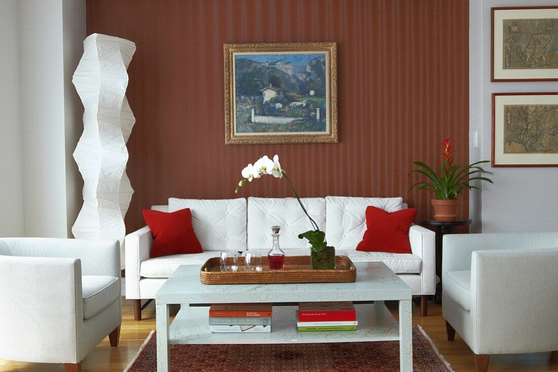 White sofa set and modern standard lamp in niche with striped wallpaper