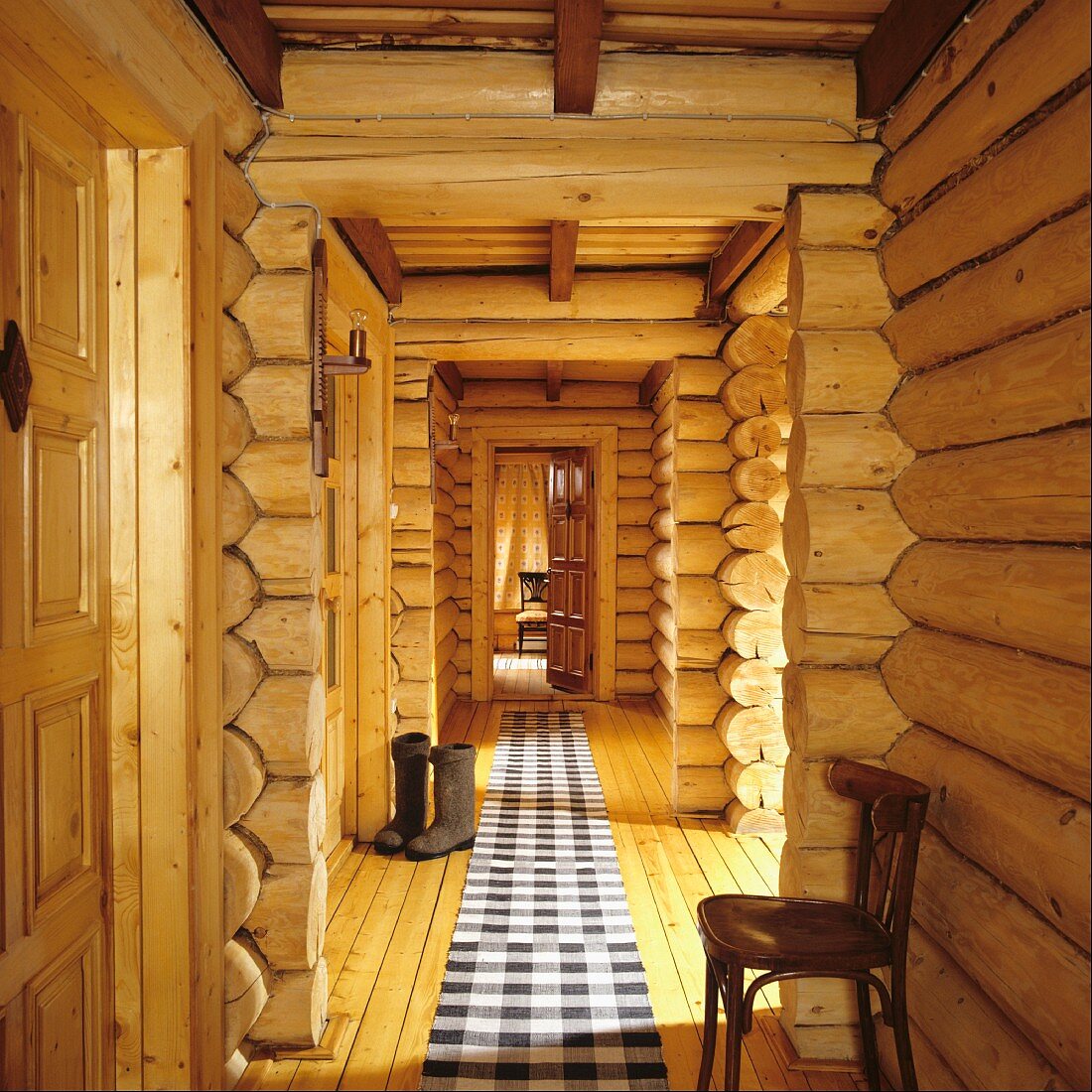 Corridor with black and white checked runner on floor in log cabin
