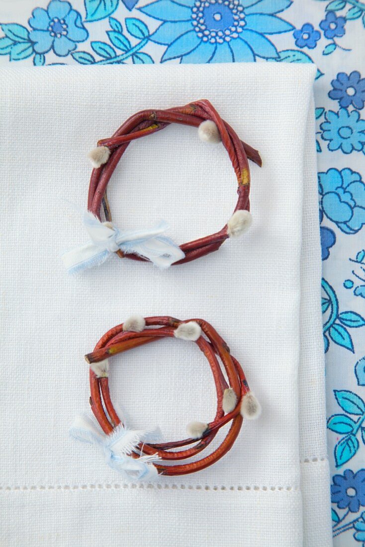Napkin rings made from pussy willow twigs on linen napkin