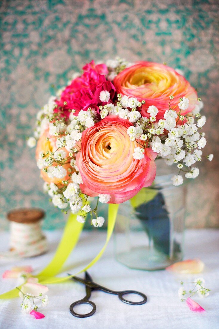 Spring posy with ranunculus and gypsophila in vase