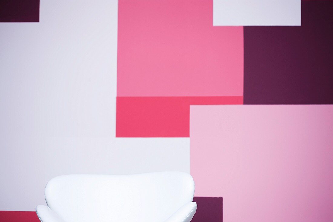 Upholstered armchair in front of a colorful wall