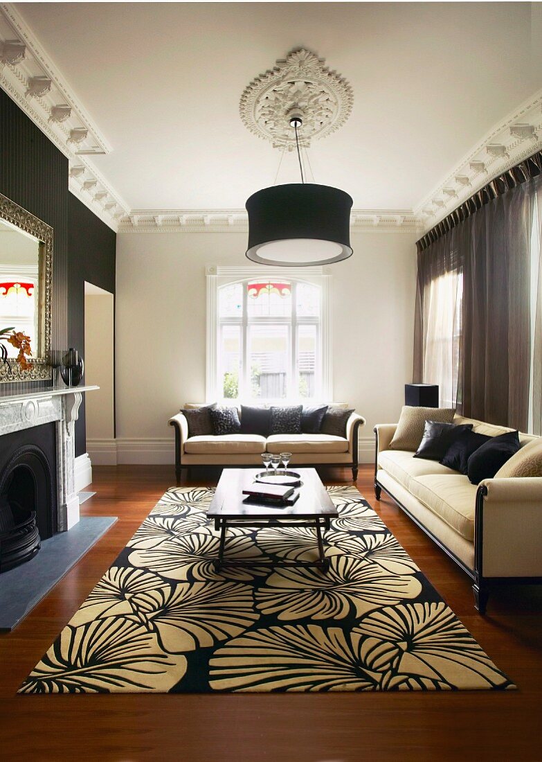 Traditional living room with black and white floral rug and elegant sofa set
