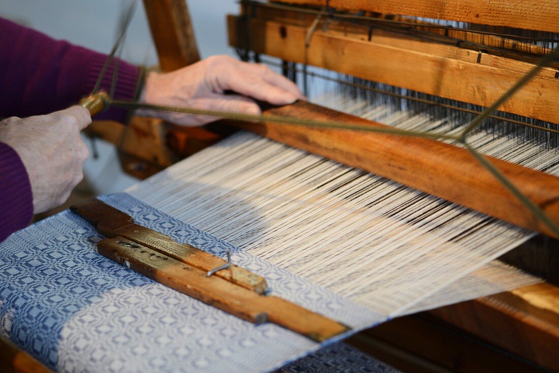 Weaver working on a loom