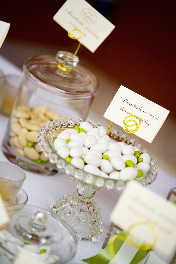 Various flavours of sugared almonds for wedding favours in glass containers