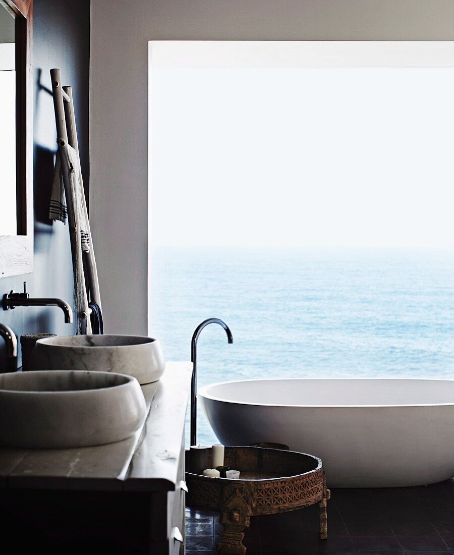 Designer bathroom with sea view through panoramic window