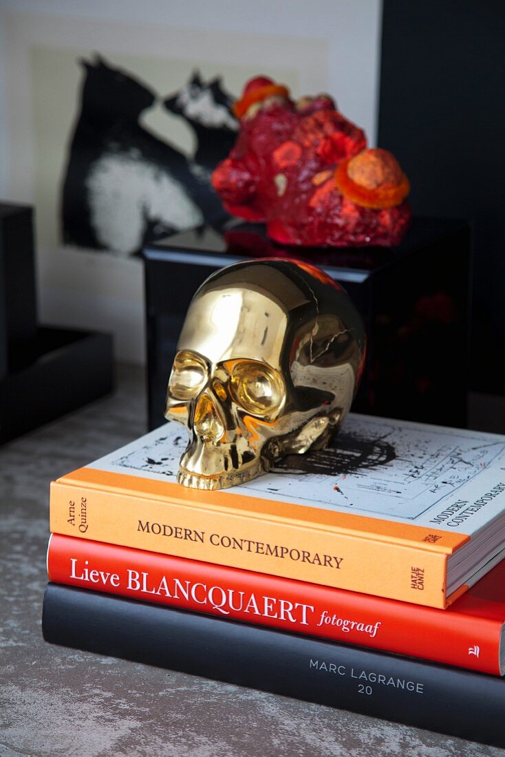 Brass skull on stack of books