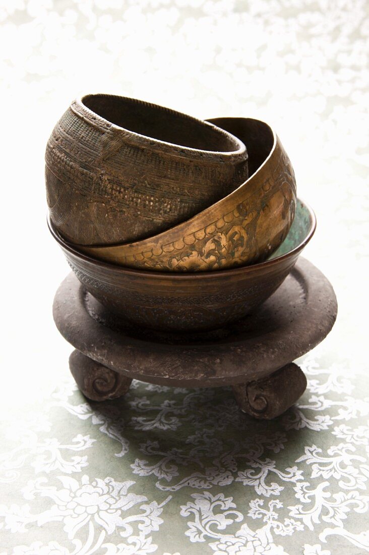 Stacked ceramic and metal bowls used for incense