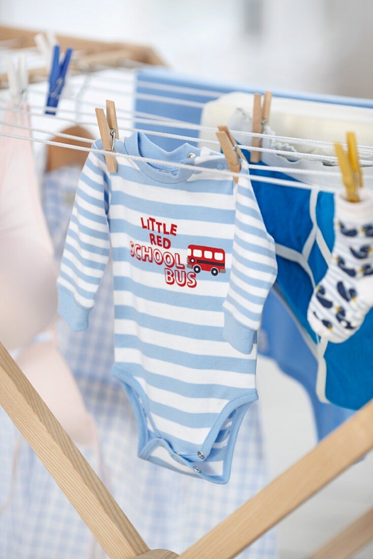 Baby clothes hanging on a clothes rack