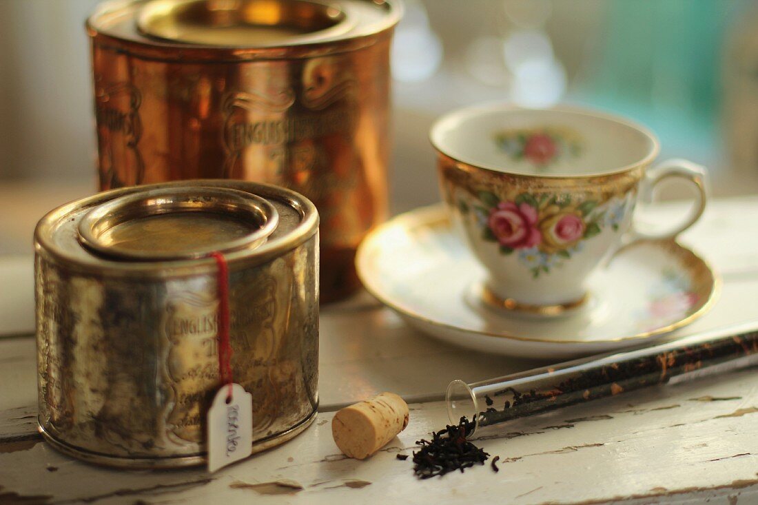 Rosentee, Teedosen und nostalgische Teetasse mit Rosenmuster